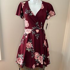 Nwt New With Tags, No Flaws Or Defects Maroon/Burgundy With Pink Floral Print V Neck, Faux Wrap Top Short, Flared Sleeves And Skirt Tie At Waist Measures 33 Inches From Shoulder To Bottom Hem 96% Polyester, 4% Spandex Casual Burgundy Short Sleeve Dress, Burgundy Short Sleeve Dress For Date Night, Casual Burgundy Dress For Date Night, Faux Wrap Top, Pink Floral Print, Faux Wrap Dress, Wrap Top, Flared Sleeves, Pink Floral