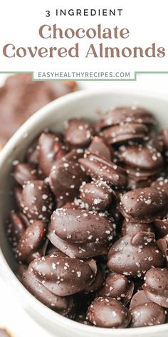 chocolate covered almonds in a white bowl