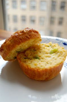 two muffins sitting on top of a blue and white plate next to a window