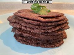 a stack of cookies on a plate with a leafy garnish atop it