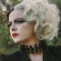 a woman with white hair and black makeup