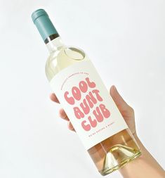 a hand holding a bottle of wine with the label cool runt club on it