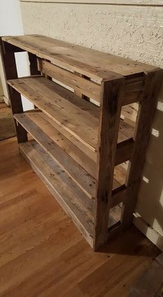 a wooden shelf sitting on top of a hard wood floor