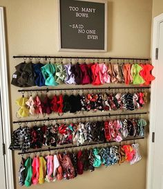 there is a rack with many different types of bow ties hanging from it's sides