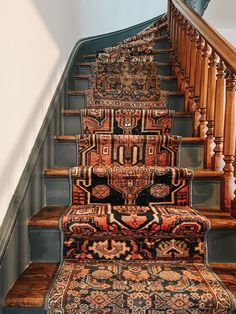 a carpeted stair case with rugs on it