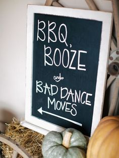 a sign that says bbq booze and bad dance moves next to some pumpkins