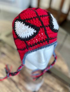 a crocheted hat on top of a white mannequin head