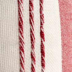 three red and white striped fabric with some thread