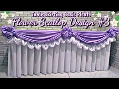 the table skirting best plants flower scallop design 3 is displayed in front of a brick wall