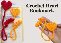 two crocheted heart bookmarks are being held in front of an open book