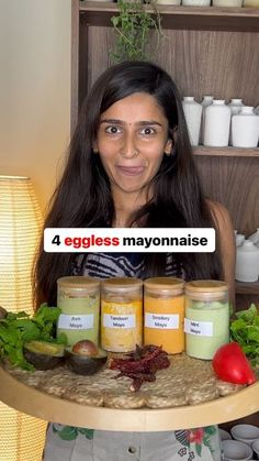 a woman is holding a tray with jars and vegetables on it that are labeled eggless mayonnaise