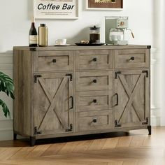 a wooden sideboard sitting in front of a wall with pictures on the wall above it