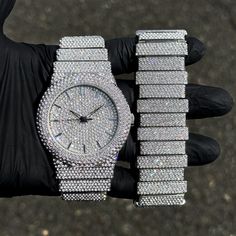 Step into elegance with this fully iced-out diamond watch and staggered bracelet set that mirrors genuine luxury watches. We utilize premium simulated diamonds crafted from high-refractive crystals, ensuring a sparkle that rivals authentic diamonds under the light! INCLUDES AN EASY-TO-USE SIZE ADJUSTMENT TOOL Specifications: - Gender: Men's - Case Size: 46mm - Sizing: 8.5-inch band - Bracelet Length: 9-inches (Non-adjustable) - Movement: Quartz Movement - Battery: Included - Adjustable: Watch Li Silver Diamond Watch With Cubic Zirconia Bling, Silver Diamond Watch With Bling, Diamond Watch With Rhinestones For Party, Silver Diamond Watch With Rhinestones, Silver Diamond Watch With Rhinestones And Crystal, Silver Diamond Watch With Cubic Zirconia For Parties, Silver Watch With Rhinestones And Cubic Zirconia, Silver Iced Out Watch Accessories For Gifts, Silver Cubic Zirconia Diamond Watch For Party