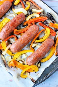 sausages and peppers are cooking in a pan