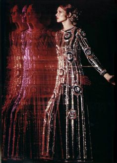 a woman in a long dress standing next to another woman wearing an evening gown with sequins on it