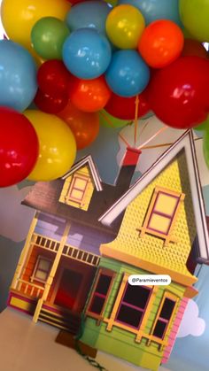 there is a house with balloons in the air