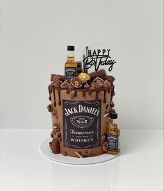 a birthday cake that is shaped like a jack daniels sign and has liquor bottles on it