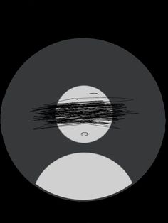 an old record with black and white lines on it's cover, in the dark