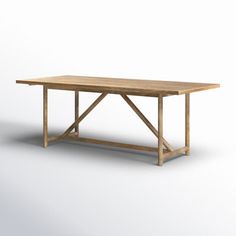 a wooden table sitting on top of a white floor