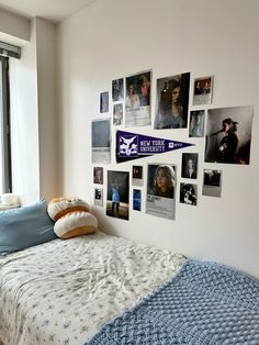 a bedroom with pictures on the wall and a bed in front of a large window