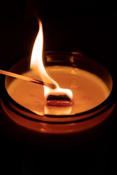 a lit candle with a matchstick sticking out of it