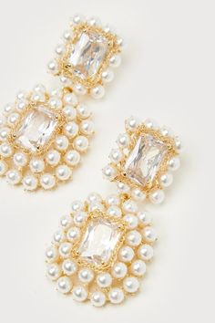 The Lulus Glamorous Ambitions White Pearl Rhinestone Statement Earrings will be the reason why everyone's eyes are on you! These statement-making earrings start with clear, rectangular rhinestones that are framed with slender gold chains and glowing faux pearl details, all connected by jump rings that create a drop-style silhouette. Post backs. 2. 25" Long And 1" Wide. 80% Glass, 20% Plated Brass. Imported. Lulus | Glamorous Ambitions White Pearl Rhinestone Statement Earrings. Party Crystal Pearl Earrings With Sparkling Stones, Sparkling Cubic Zirconia Pearl Earrings For Party, Party Sparkling Cubic Zirconia Pearl Earrings, Pearl Jeweled Earrings For Party, Gold Rectangular Crystal Earrings For Party, Rectangular Crystal Jewelry For Party, Rectangular Crystal Earrings For Party, Glamorous Gold Rectangular Jewelry, Glamorous Wedding Earrings