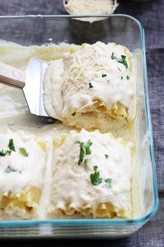 a glass casserole dish filled with ravioli and cheese