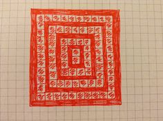 a red and white square drawn on top of a piece of paper