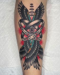 a tattoo on the leg of a person with an all seeing eye and arrows around it