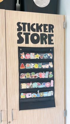 the sticker store sign is on display in front of a wooden cabinet with magnets