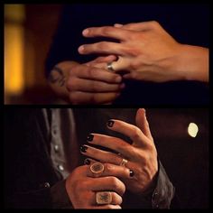 two hands holding each other with rings on them