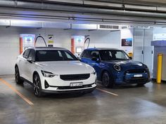 two cars parked in a parking garage next to each other