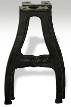 an iron stool with two legs and one foot in the shape of a letter b