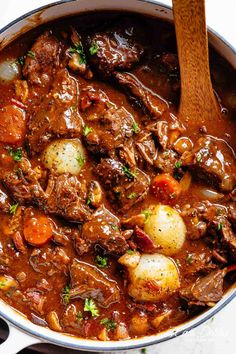 beef stew with potatoes and carrots in a large pot, ready to be eaten