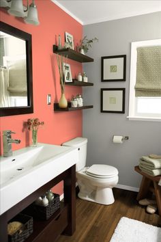 a bathroom with green walls and white fixtures