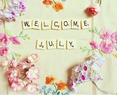 the word welcome is spelled with scrabbles and flowers