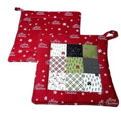 two red placemats with christmas designs on them