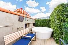 an outdoor hot tub on the roof of a building