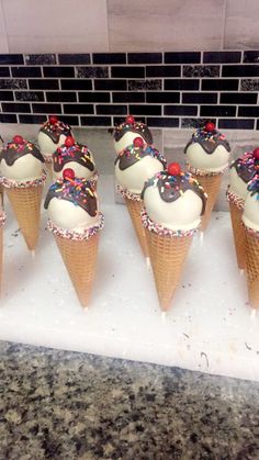 ice cream cones with sprinkles are lined up on a counter