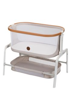 a white and brown baby bassinet with an orange trim on the bottom, in front of a white background