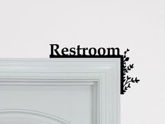 a white door with the word restroom on it