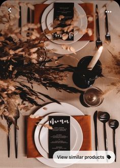 the table is set with black and white place settings