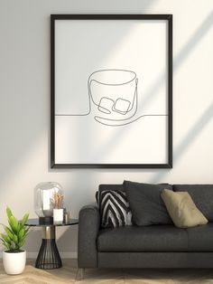 a living room with a couch, coffee table and framed artwork