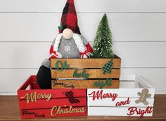 a wooden crate filled with christmas decorations on top of a table next to other boxes