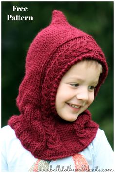 a young boy wearing a red knitted hat and scarf with a hood on his head