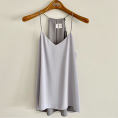 Express Barcelona Reversible Cami Tank Features Reversible Style, Light Grey One Side, Dark Grey Reverse Side Thin Strap Cami Layered Chiffon Fabric V-Neck Neckline With High Low Hemline 100% Polyester Size Small Pit To Pit 17”. Length Front 23". Length Back 27" New With Tags Cami Tanks, Chiffon Fabric, Gray White, High & Low, High Low, Dark Grey, Light Grey, Barcelona, Chiffon