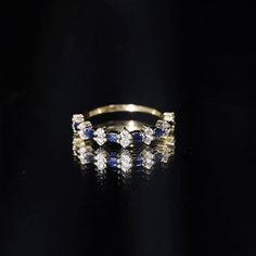 Product Details Surprise the one you love with this beautiful Blue Sapphire and Diamond Ring. Designed with a classic East West style, this half eternity ring features a gorgeous Round Shape blue sapphire as the center gemstone set in a prong setting. Accented with sparkling Diamond stones, this ring is crafted for a stunning and durable piece of jewelry. Show your love and commitment with this gorgeous ring. Product Information SKU SHP-RINGS0821183767 Width 1.8 mm Height 4 mm Weight 1.29 gm (Approximate) BLUE SAPPHIRE INFORMATION No.of Stones 7 Pieces Total Weight 0.21 Carat (Approximate) Dimension(approx) Marquise-1.50X3.00 mm-7 Pcs Color Blue Cut Brilliant Shape Marquise Setting Type Prong-Setting Quality Grade AAA DIAMOND INFORMATION No.of Stones 16 Pieces Total Weight 0.40 Carat (Appr Elegant Blue Eternity Band, Blue Sapphire Half Eternity Ring In 14k Gold, Elegant Sapphire Eternity Band With Prong Setting, Classic Sapphire Ring Half-eternity, Elegant Yellow Gold Sapphire Eternity Band, Formal Sapphire Diamond Ring With Half Eternity Setting, Formal Sapphire Diamond Ring With Half Eternity, Formal Blue Sapphire Eternity Band, Luxury Sapphire Half Eternity Promise Ring