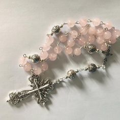 Beautiful natural Rose Quartz Anglican prayer beads o I have made this using rose Quartz beads, Tibetan silver beads,  Silver plated spacer beads, Tibetan connecter, Tibetan cross and finished with silver tone wire work The cross measures 2" Thank you for visiting my shop. If there is a particular piece you like but would prefer it in another colour, shortened or lengthened please contact me I can usually meet your requirements  A pretty silk brocade pouch is available for you to keep your item Adjustable Rose Gold Spiritual Rosary, Pink Healing Rosary With 8mm Beads, Adjustable Silver Rosary For Meditation, Spiritual Silver Beads Rosary Gift, Silver Beaded Rosary For Meditation, Silver Beaded Spiritual Rosary, Silver Spiritual Rosary Bracelet With Gemstone Beads, Silver Beaded Rosary With Spiritual Style, Spiritual Silver Beaded Rosary