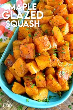 a blue bowl filled with cooked squash on top of a wooden table