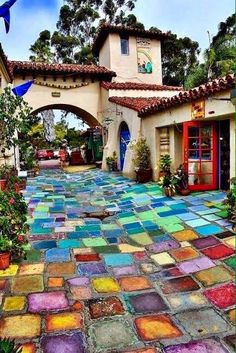 an outdoor courtyard with colorful tiles on the ground